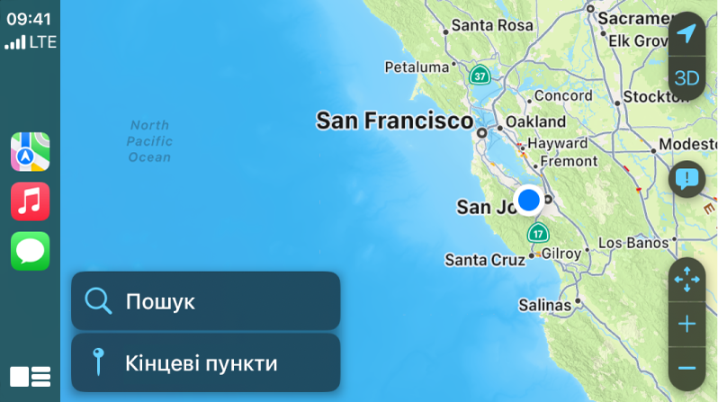 CarPlay з іконками для Карт, Музики й Телефону ліворуч і картою поточного району праворуч.
