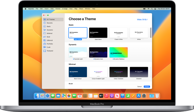 A MacBook Pro with the Keynote theme chooser open on the screen. The All Themes category is selected on the left and pre-designed themes appear on the right in rows by category. The Language and Region pop-up menu is in the bottom-left corner and the Standard and Wide pop-up menu is in the top-right corner.