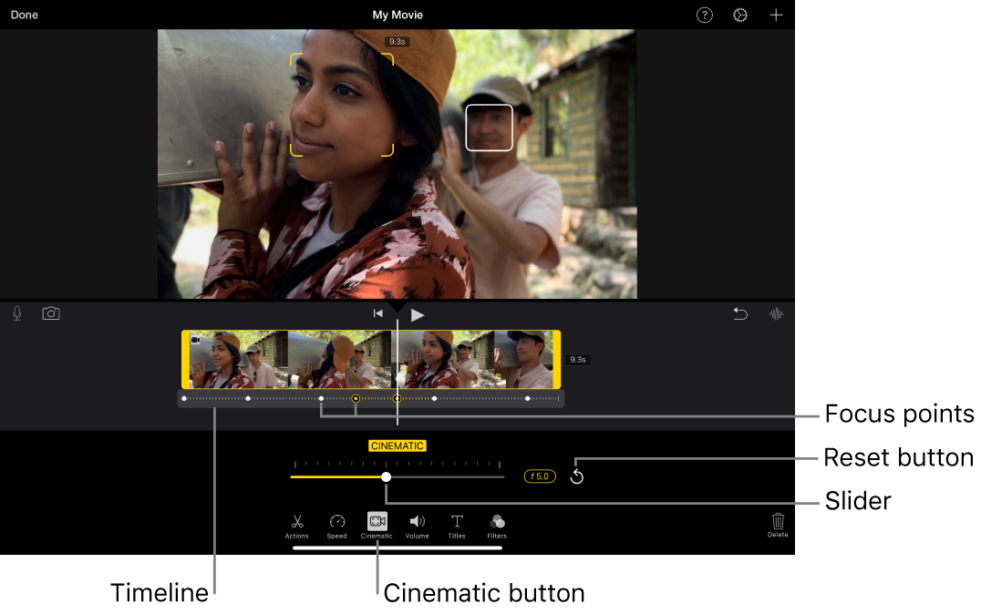 A Cinematic mode video clip in the viewer, with yellow brackets around the object currently in focus and a white box around an object not in focus. The timeline shows white and yellow focus points.