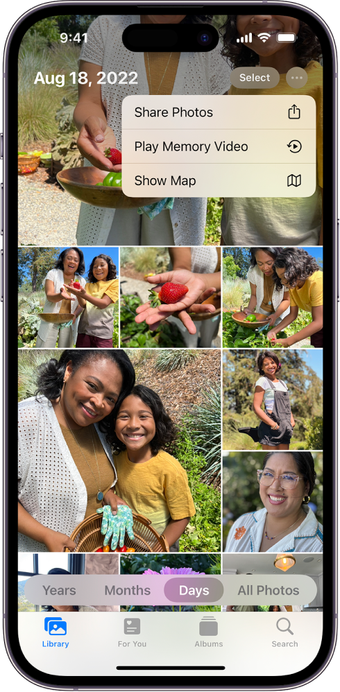 The Photos screen showing the photos library; at the bottom of the screen Days is selected. The More options menu is open at the top of the screen showing options to Share Photos, Play Memory Video, and Show Map.