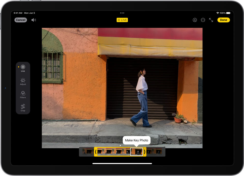 A Live Photo is in the center of the Edit screen in the Photos app. The frame viewer is across the bottom of the video and a yellow outline is around the selected frames to include in the edited Live Photo; a single frame is selected to make key photo. The editing tools are on the left side of the screen: from the top to bottom, Live Photo, Adjust, Filters, and Crop. Live Photo is selected.