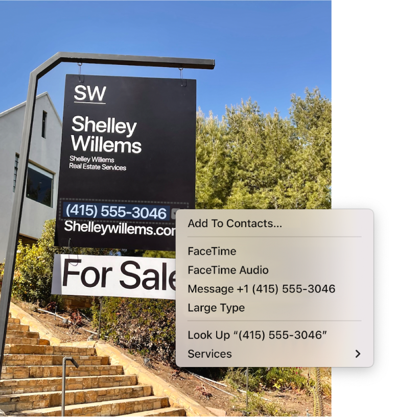 Photo of a For Sale sign showing the estate agent’s phone number selected as Live Text and a menu presenting options to add the phone number to Contacts, call the number, start a FaceTime call, send a text message and more.
