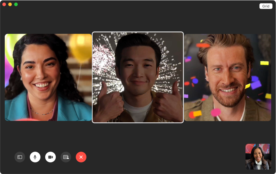 A FaceTime window showing three people with animated backgrounds. The person in the middle is making a thumbs-up gesture with both hands.