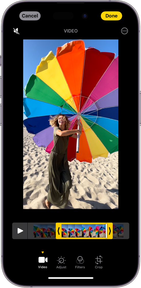 The Edit screen in the Photos app with a video playing in the viewfinder. The video’s frame viewer is across the bottom of the video and a yellow outline is around the selected frames to include in the trimmed video. On the bottom of the screen are the Video, Adjust, Filters, and Crop buttons; the Video button is selected.