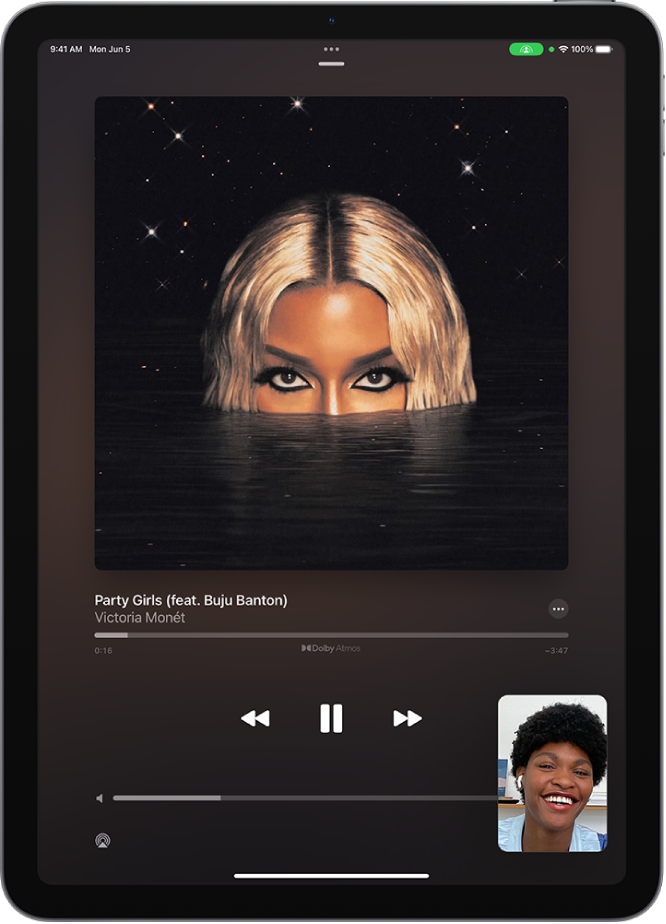 A FaceTime call showing a SharePlay session, with Apple Music content being shared in sync with everyone on the call. An image of the person sharing the content is shown at the bottom right, an image of the album being shared is near the top of the screen, and the playback controls are below the album image.