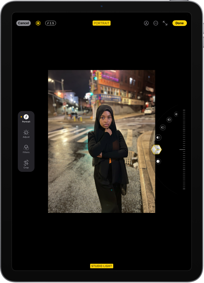 The Edit screen of a Portrait mode photo. The photo is in the center of the screen and on the right side of the screen are the Portrait Lighting effect options. Studio Light is selected and there is a slider to adjust the level of the effect. On the left side of the screen are the Portrait, Adjust, Filters, and Crop buttons. The Portrait button is selected.