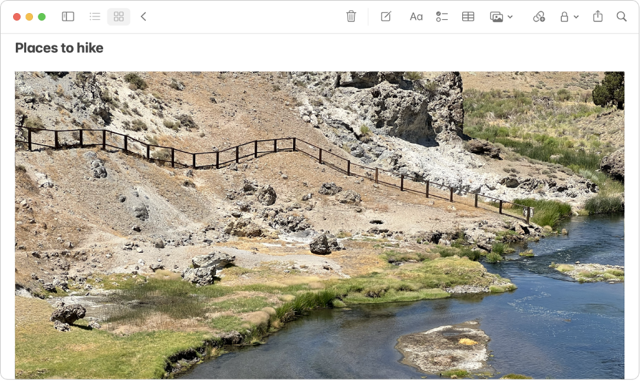 A note that includes a large photo of a hill and a river.