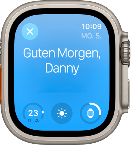 Apple Watch mit der Begrüßung beim Aufwachen. Oben wird „Guten Morgen“ angezeigt. Darunter stehen Informationen zum Batterieladezustand.