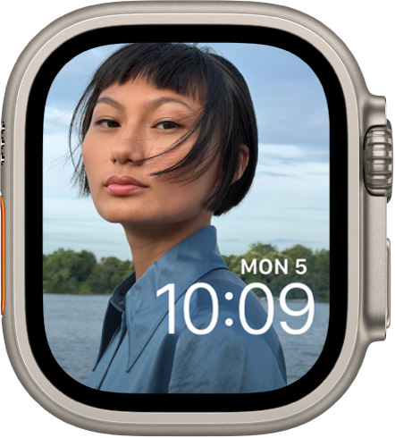 The Photos watch face shows a photo from your synced photo album. The date and time is near the bottom right.