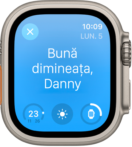 Apple Watch afișând ecranul de trezire. Cuvintele “Bună dimineața” apar în partea de sus. Nivelul bateriei este dedesubt.