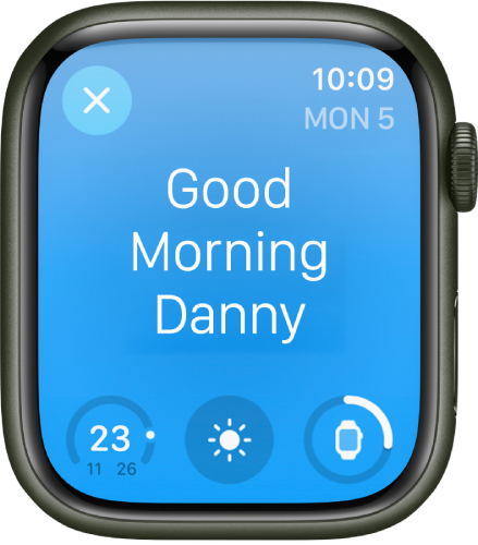 Apple Watchi ekraanil on äratuskuva. Üleval kuvatakse sõnu “Good Morning”. Aku laetuse taset kuvatakse all.