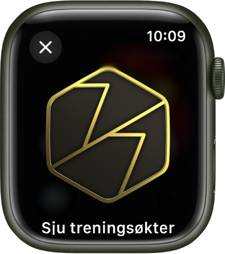 Det vises en utmerkelse på Apple Watch. Det vises en beskrivelse av utmerkelsen under den. Du kan dra for å snu på merket.