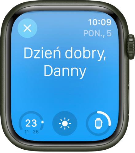 Apple Watch wyświetlający ekran pobudki. Na górze widoczny jest napis Dzień dobry. Poniżej widoczny jest poziom naładowania baterii.