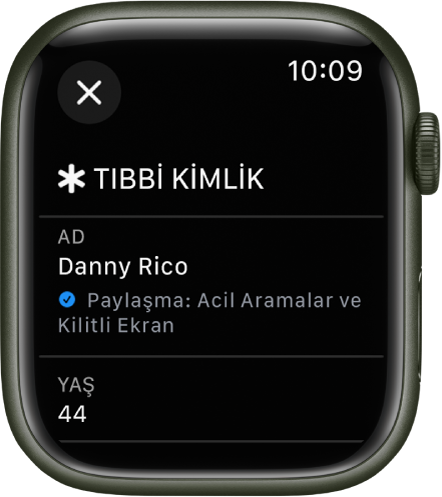 Apple Watch’taki Tıbbi Kimlik ekranı kullanıcının adını ve yaşını gösteriyor. Adın altında bir onay işareti var, Tıbbi Kimlik’in kilitli ekranda paylaşıldığını gösteriyor. Kapat düğmesi sol üstte.