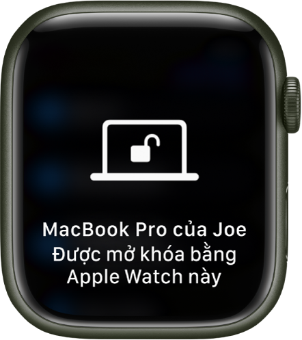 Màn hình Apple Watch đang hiển thị thông báo: “Đã mở khóa MacBook Pro của Joe bằng Apple Watch này”.