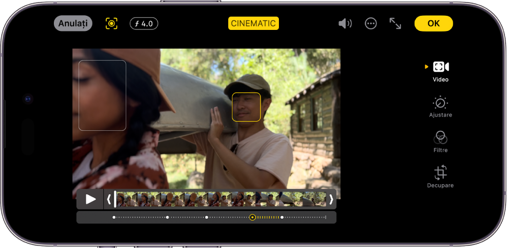 Ecranul de editare a unui clip video în modul Cinematic, în orientare peisaj. În partea din stânga sus a ecranului se află butonul Anulați, butonul Cinematic manual și butonul Ajustare adâncime. În mijlocul părții de sus a ecranului este selectat butonul Cinematic. În dreapta părții de sus a ecranului se află butonul Volum, butonul Mai multe opțiuni, butonul Afișați pe tot ecranul și butonul OK. Clipul video este în centrul ecranului și în jurul subiectului focalizării se află un cadru. Sub clipul video este vizualizorul de cadre, care afișează punctul din materialul video unde se schimbă subiectul focalizării. Butoanele de editare sunt în partea dreaptă a ecranului, de sus în jos: Video, Ajustați culoarea, Filtre și Decupați.
