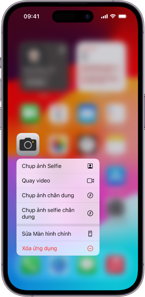Một Màn hình chính được làm mờ, với menu tác vụ nhanh Camera đang hiển thị bên dưới biểu tượng ứng dụng Camera.