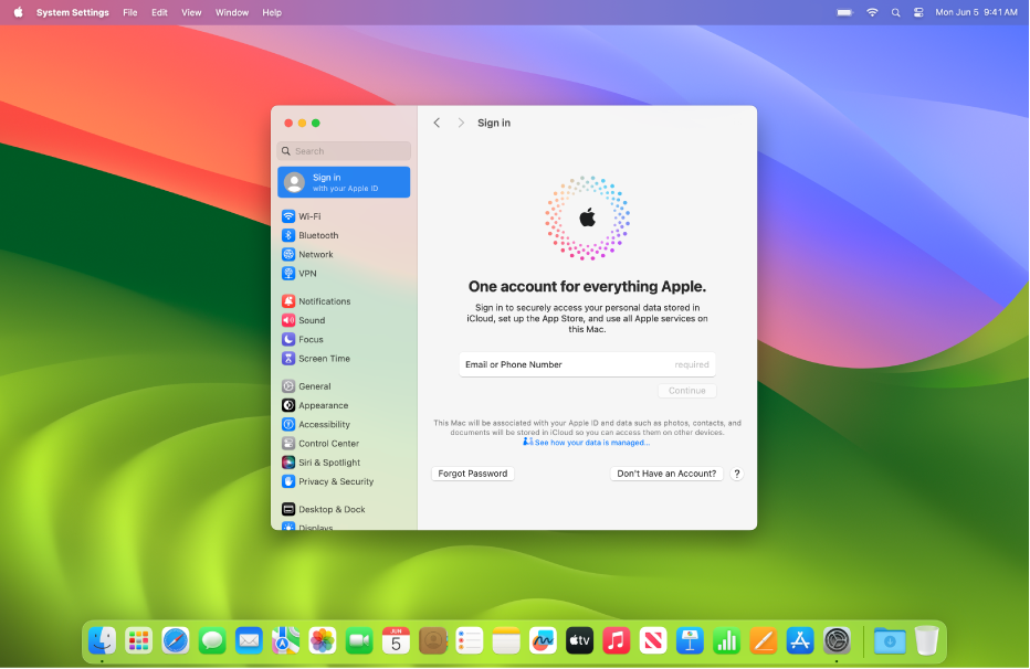 Bureau d’un Mac avec Réglages système ouvert, montrant les réglages de connexion avec l’identifiant Apple.