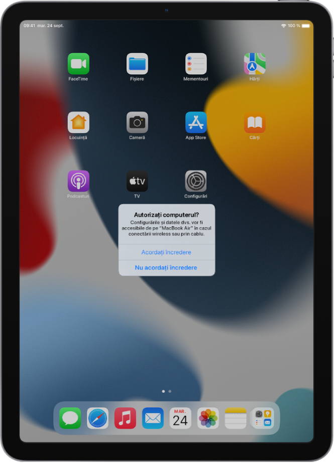 Un iPad pe care se afișează dialogul “Autorizați computerul?” la prima conectare la un MacBook Pro.