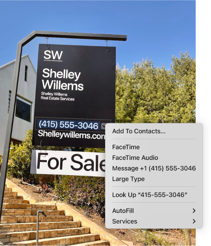 Photo of a Real Estate For Sale sign showing the agent’s phone number selected as Live Text and a menu presenting options to add the phone number to Contacts, call the number, start a FaceTime call, send a text message and more.