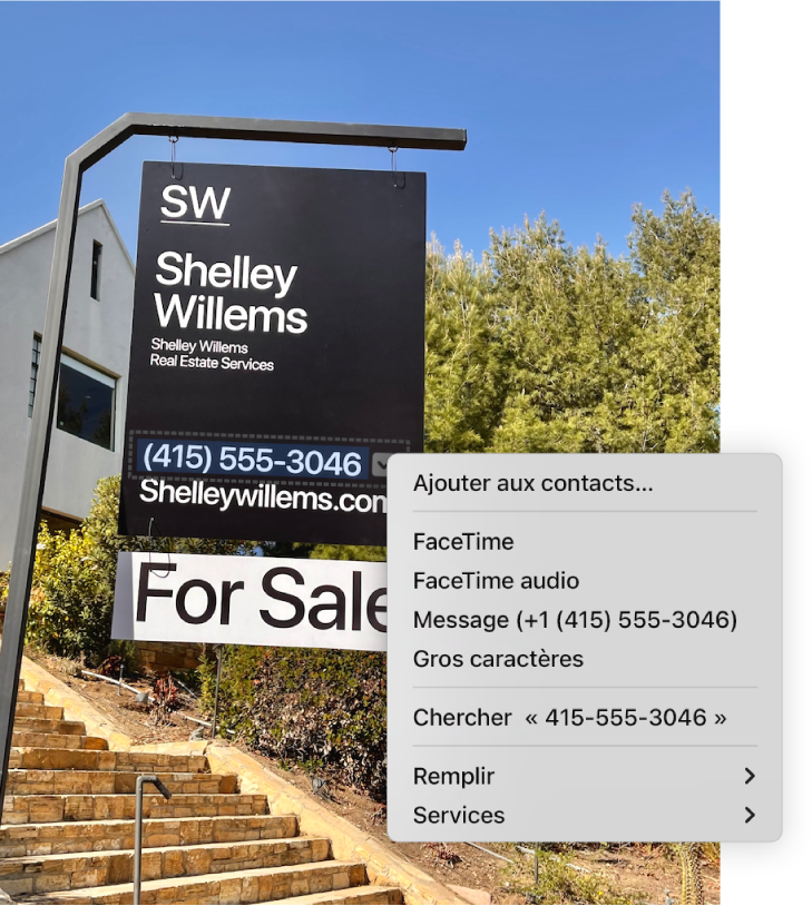 Photo d’une pancarte « Bien à vendre » affichant le numéro de téléphone de l’agent sélectionné avec « Texte en direct », ainsi qu’un menu avec des options pour ajouter le numéro de téléphone à Contacts, appeler le numéro, lancer un appel FaceTime, envoyer un message texte et effectuer d’autres actions.
