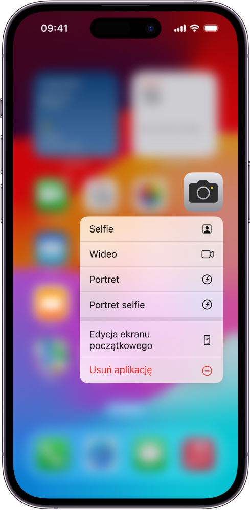 Rozmazany ekran początkowy; pod ikoną aplikacji Aparat wyświetlane jest menu szybkich czynności.