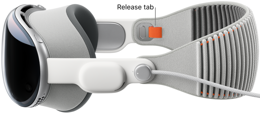 Apple Vision Pro with the Solo Knit Band attached. An orange release tab is visible on the inside of the Solo Knit Band.