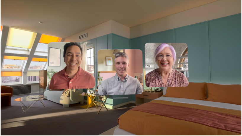 A FaceTime call on Apple Vision Pro, showing three tiles from other participants overlaying the user’s room.
