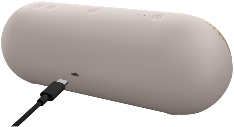 USB-C cable next to the charging port on the back of the Beats Pill speaker.