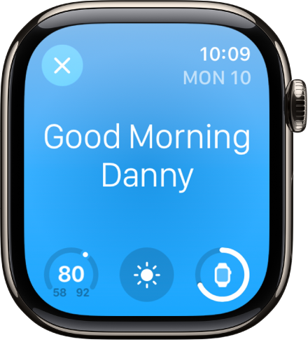 Apple Watch showing the wake up screen. The words Good Morning appear at the top. The temperature, weather condition, and battery level are below.