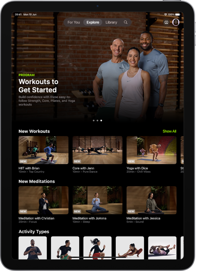 The Explore screen in Apple Fitness+ showing a featured workout programme, new workouts and meditations, and available activity types.