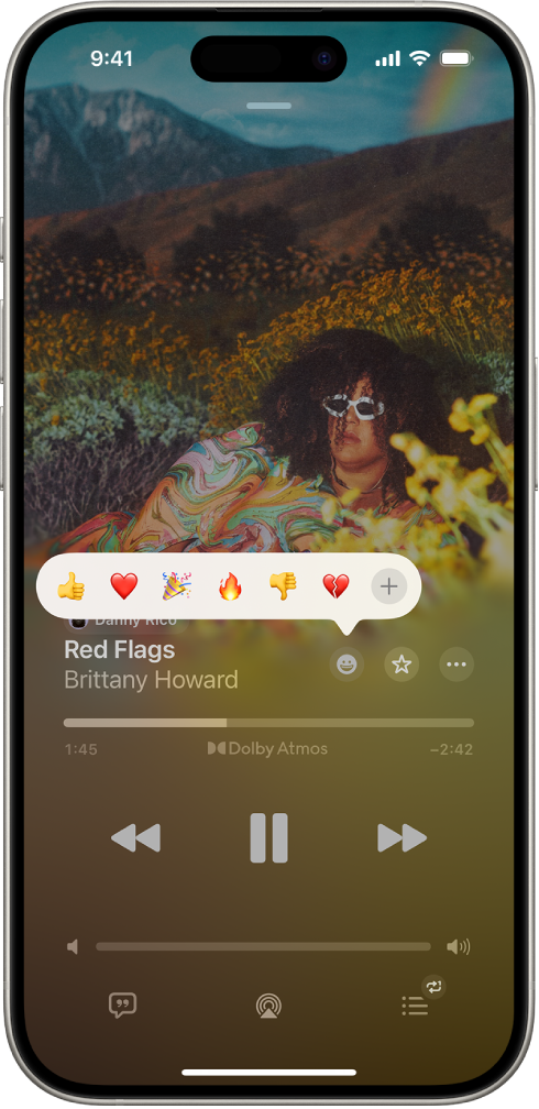 La schermata “In riproduzione” con il pulsante delle reazioni con diverse emoji e il pulsante Aggiungi che può essere selezionato per trovare altre emoji.