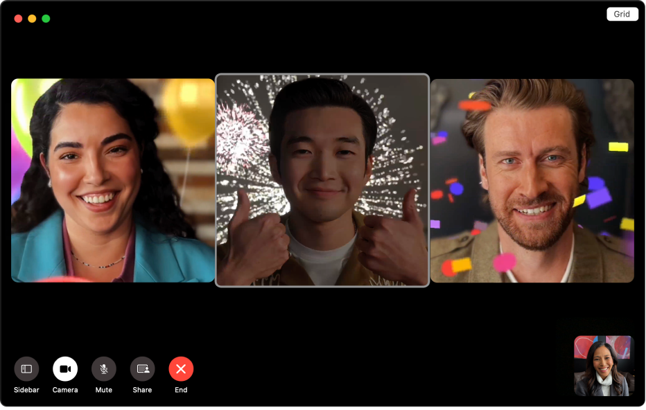 A FaceTime window showing three people with animated backgrounds. The person in the middle is making a thumbs-up gesture with both hands.