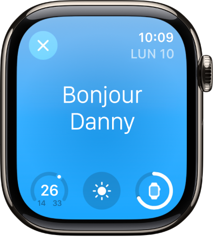 L’Apple Watch affichant l’écran de réveil. Le mot « Bonjour » apparaît en haut. La température, la météo et le niveau de la batterie s’affichent en dessous.