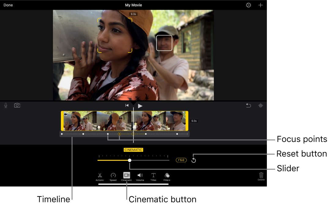 A Cinematic mode video clip in the viewer, with yellow brackets around the object currently in focus and a white box around an object not in focus. The timeline shows white and yellow focus points.