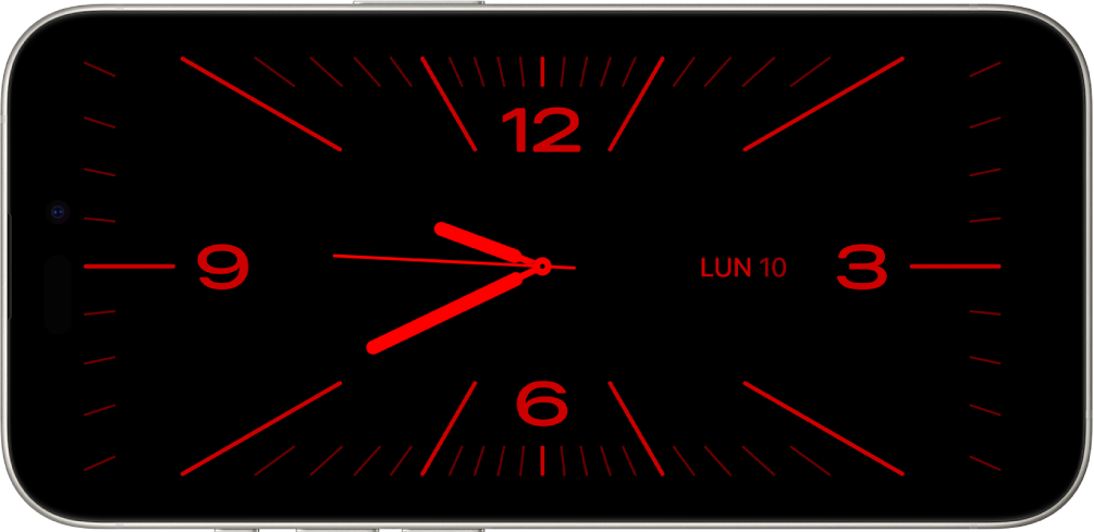 iPhone en modo “En reposo” con poca luz ambiente que muestra los widgets Reloj y Calendario con un tono rojo.