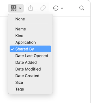 The group button in the Finder window toolbar with the group pop-up menu open and the Shared By option selected.