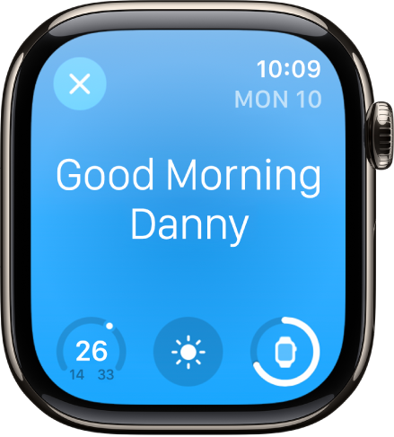 Apple Watch, показващ екрана за събуждане. В горния край се появяват думите Good Morning (Добро утро). Отдолу са температурата, атмосферните условия и зарядът на батерията.