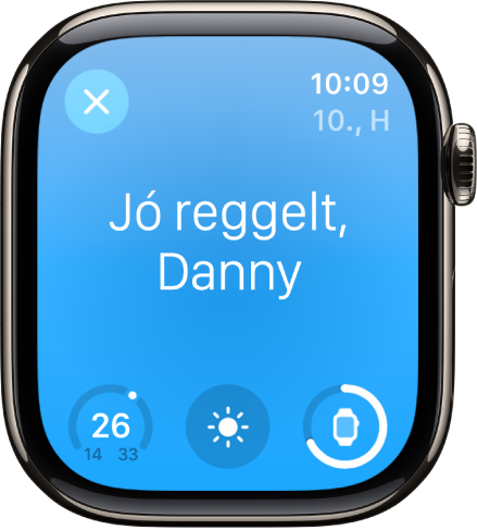 Az Apple Watch az ébredési képernyővel. Felül a „Jó reggelt!” felirat olvasható. Alatta a hőmérséklet, az időjárási körülmények és az akkumulátor töltöttségi szintje látható.