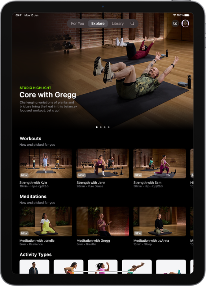 The Explore screen in Apple Fitness+ showing a featured workout programme, new workouts and meditations, and available activity types.