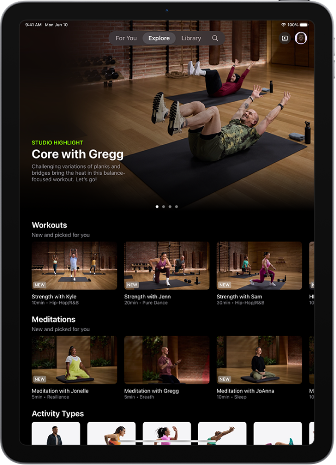 The Explore screen in Apple Fitness+ showing a featured workout program, new workouts and meditations, and available activity types.