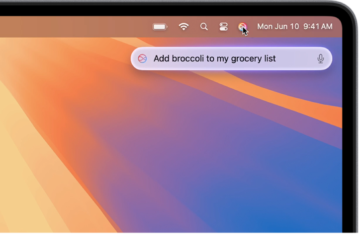 Pravý horní roh plochy Macu zobrazující ikonu Siri v řádku nabídek a pole Zadávání textu pro Siri s požadavkem „Add broccoli to my grocery list“ (Přidat brokolici do nákupního seznamu)