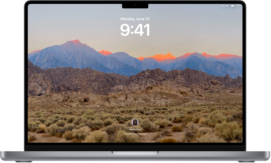 Skrin Kunci dengan foto gunung gurun disetkan sebagai gambar desktop. Gambar profil pengguna yang sedang dilog masuk kelihatan di bahagian bawah skrin.