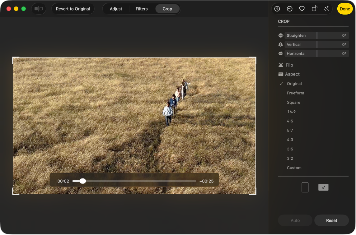 A video in editing view, showing handles on the corners that you can drag to crop the video. On the right side are sliders that you can drag to straighten the video.