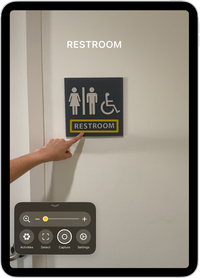 The Magnifier app detecting a finger pointing at text on a wall.