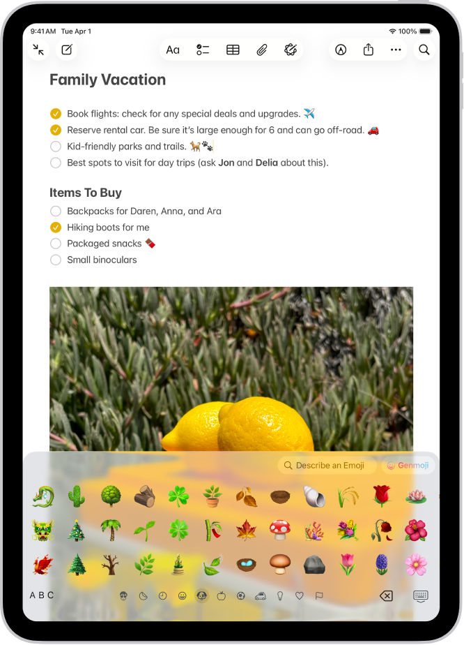 A note is open in the Notes app in the top of the screen, and the emoji keyboard is open in the bottom of the screen.