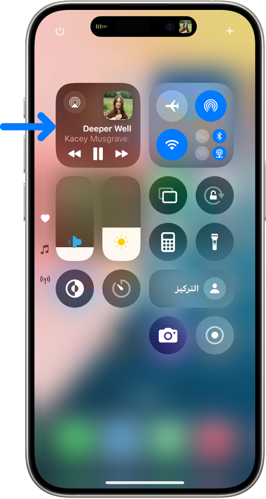 مركز التحكم في iPhone يظهر به سهم يشير إلى بطاقة الصوت حيث يمكنك التحكم في الموسيقى من شاشة القفل أو عند استخدام تطبيق آخر.