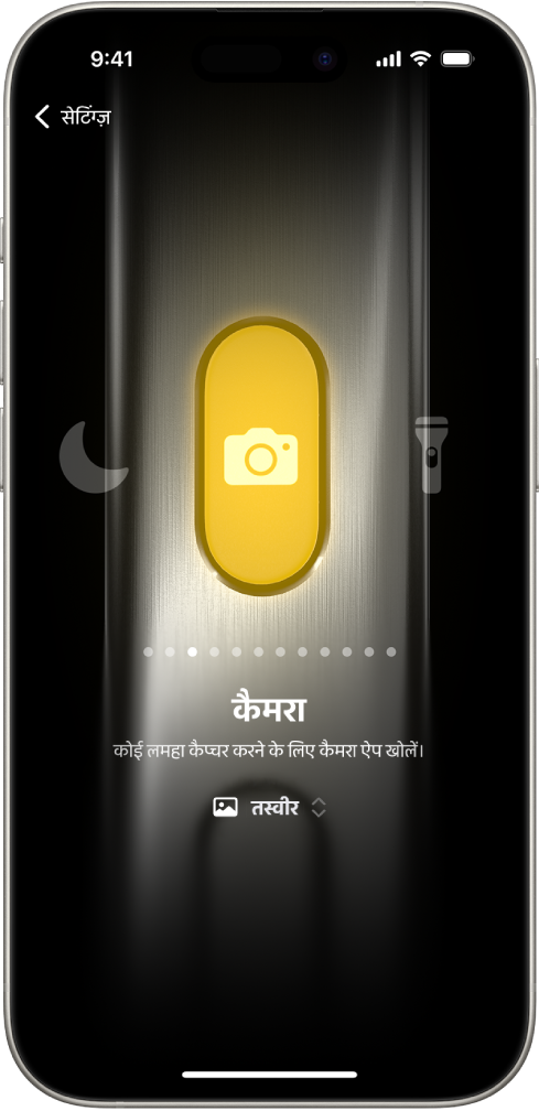 ऐक्शन बटन को कस्टमाइज़ करने की स्क्रीन। चुनी गई क्रिया कैमरा है। अन्य फ़ीचर कैमरे के दाईं और बाईं ओर दिखाई देते हैं, जिनमें डू नॉट डिस्टर्ब और टॉर्च शामिल हैं। क्रियाओं के नीचे डॉट मौजूद हैं जिन पर आप किसी अन्य क्रिया पर स्विच करने के लिए टैप कर सकते हैं। चुनी गई क्रिया के नीचे मौजूद कैमरा, कैमरा विकल्पों का मेनू है जिन पर आप ऐक्शन बटन को असाइन करने के लिए टैप कर सकते हैं।
