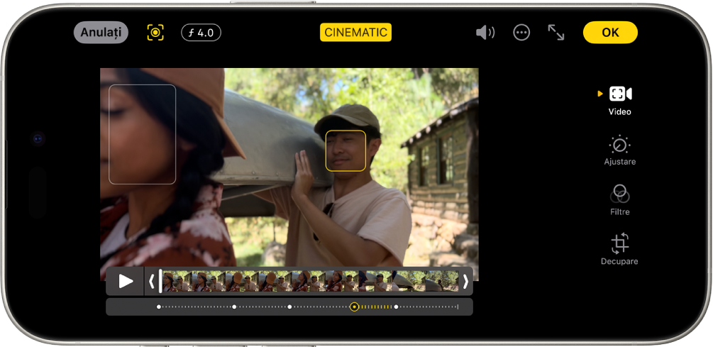 Ecranul de editare a unui clip video în modul Cinematic. În partea din stânga sus a ecranului se află butonul Anulați, butonul Cinematic manual și butonul Ajustare adâncime. În mijlocul părții de sus a ecranului este selectat butonul Cinematic. În partea din dreapta sus a ecranului se află butonul Volum, butonul Mai multe, butonul Afișați pe tot ecranul și butonul OK. Clipul video este în centrul ecranului și în jurul subiectului focalizării se află un cadru. Sub clipul video este vizualizorul de cadre, care afișează punctul din materialul video unde se schimbă subiectul focalizării. Butoanele de editare sunt în partea dreaptă a ecranului, de sus în jos: Video, Ajustare, Filtre și Decupați.