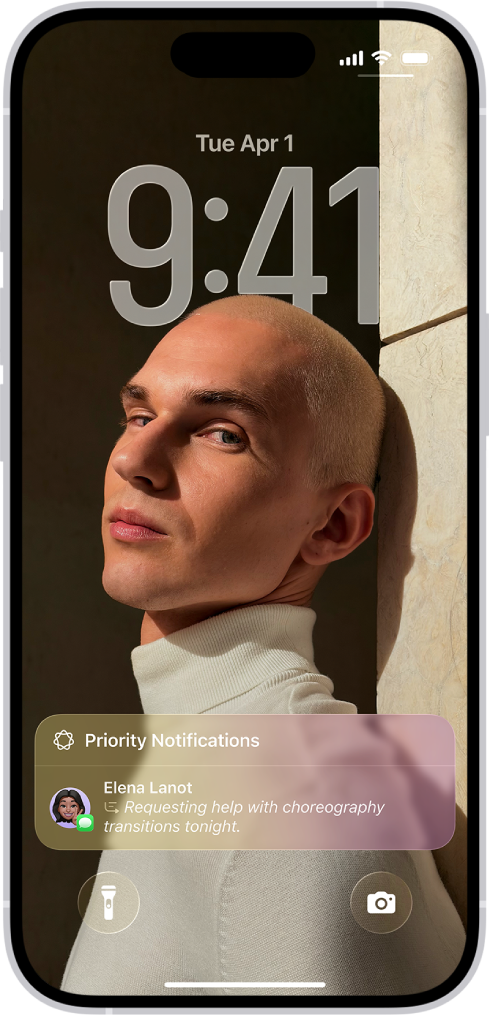 An iPhone showing the Lock Screen. A summarized time-sensitive notification appears at the bottom of the screen.